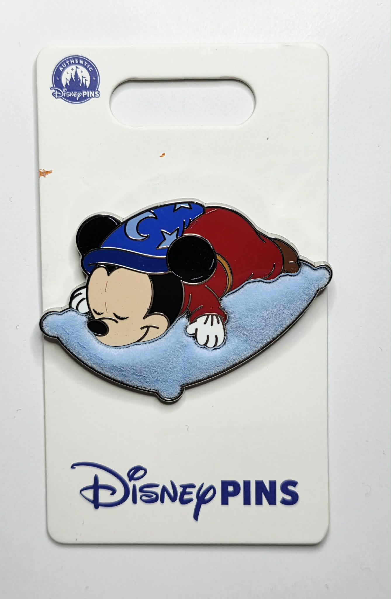 Mickey sleeping on a flocked blue pillow