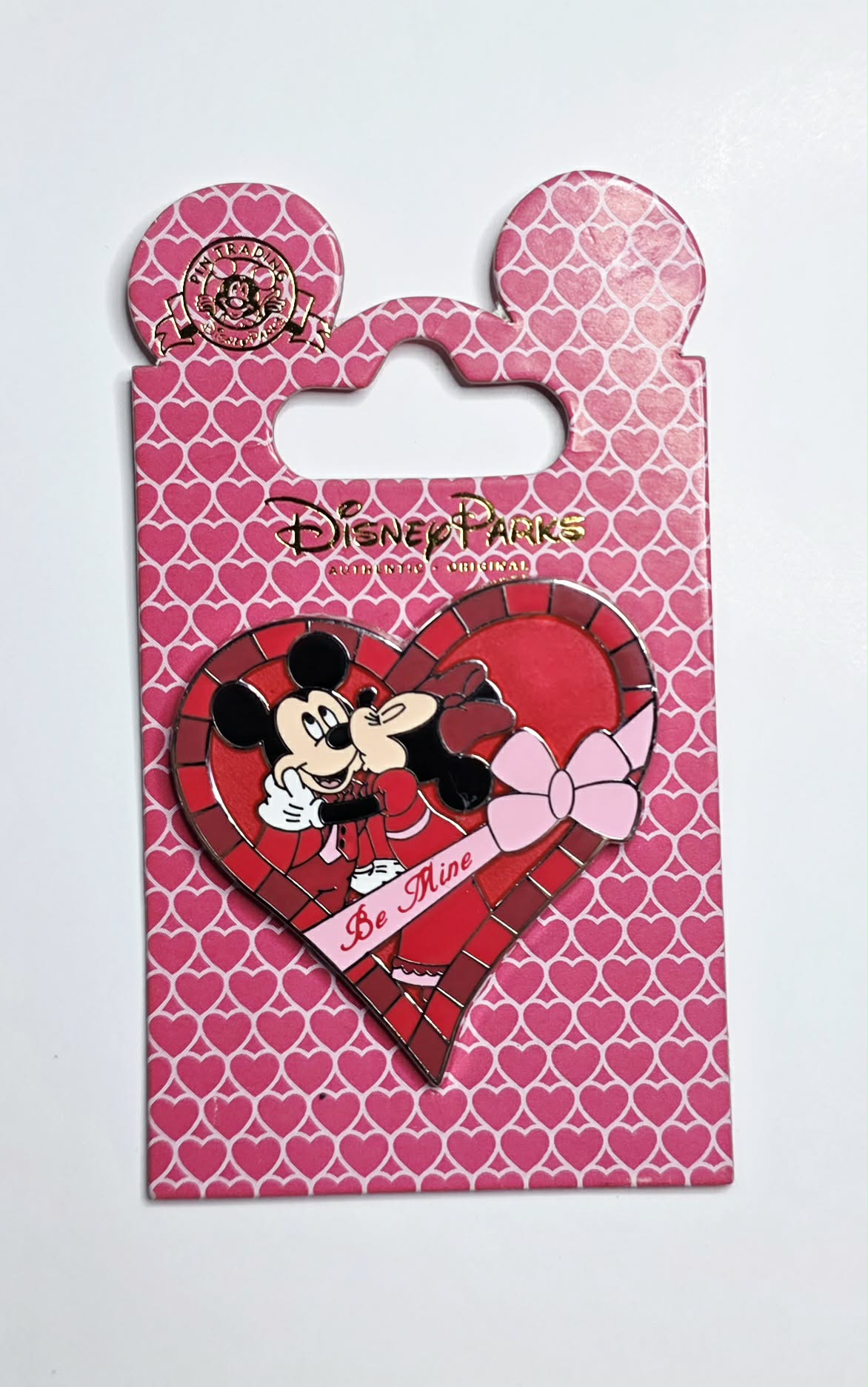 Disney Parks Valentine's Day pin featuring Mickey Mouse and Minnie Mouse sharing a kiss.