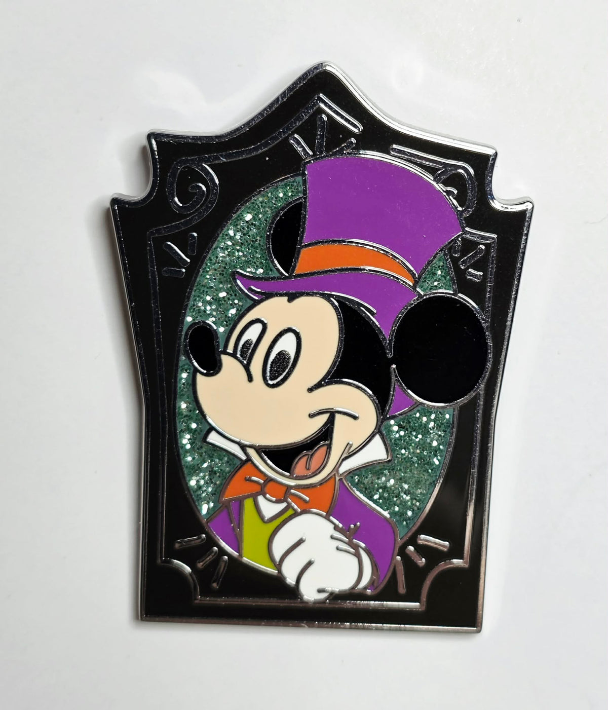 Mickey Mouse wearing a purple top hat and orange bow tie
