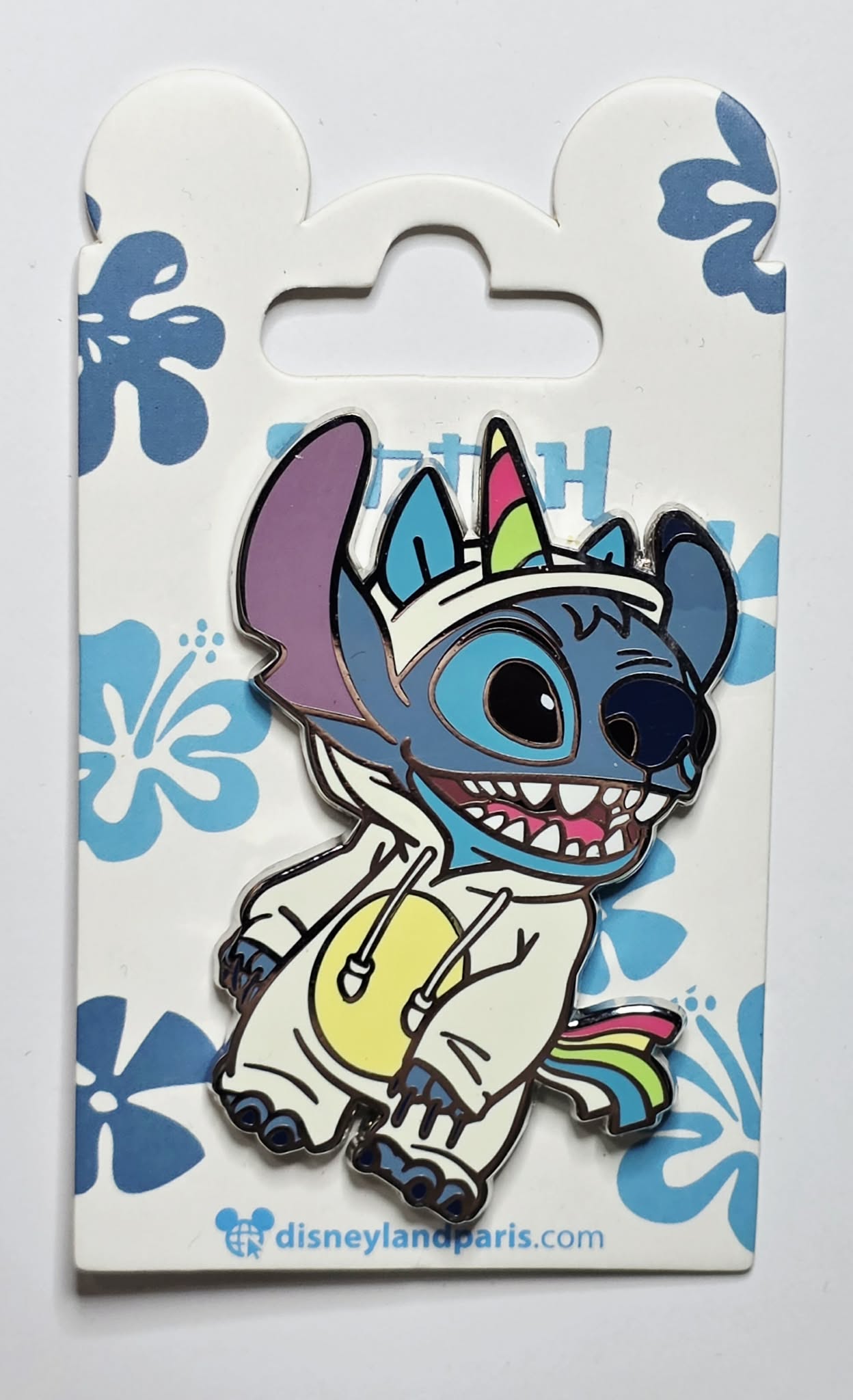 Stitch dressed in a white unicorn onesie