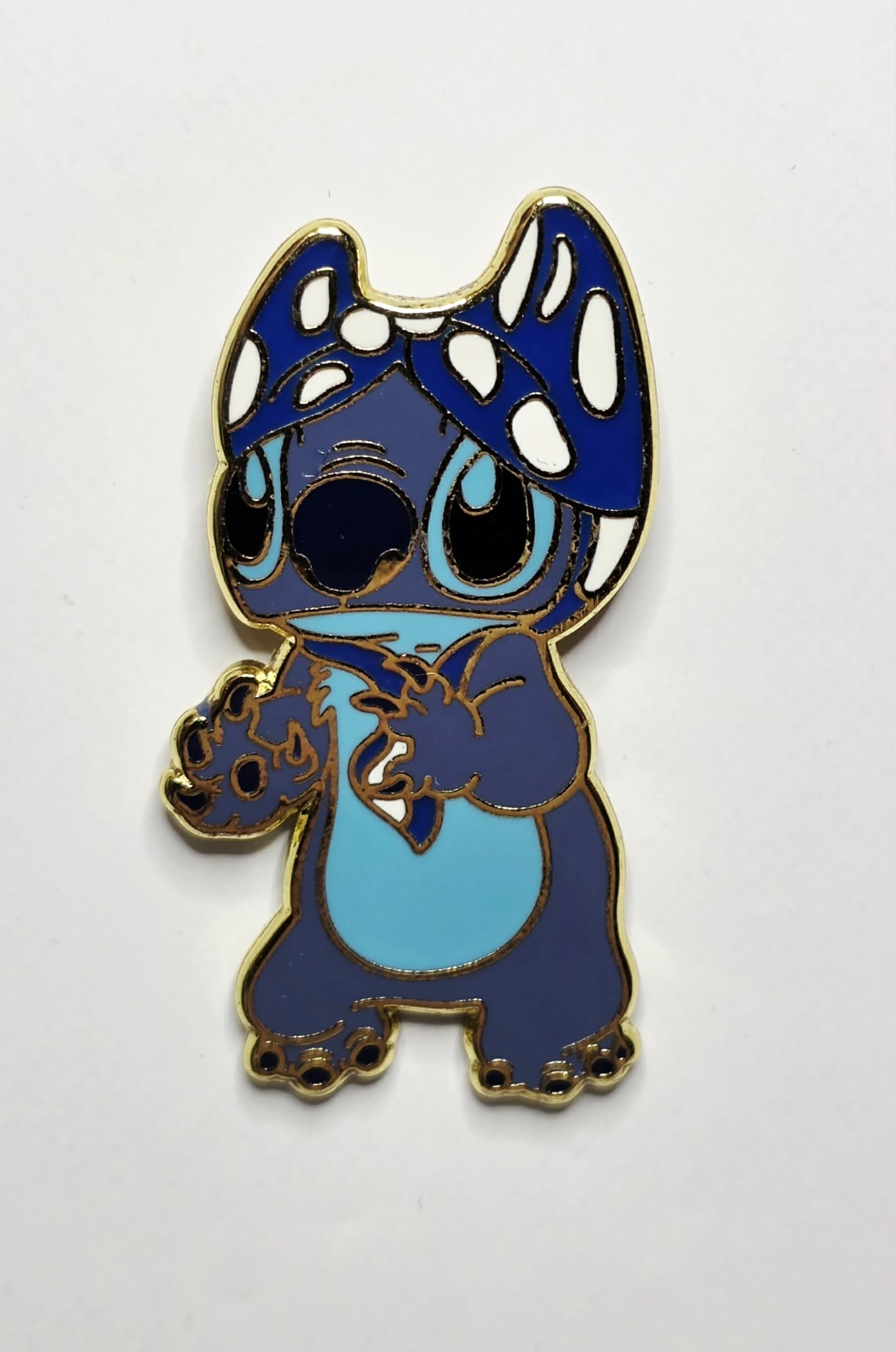 Lilo and Stitch - Stitch wearing a blue and white polka-dotted bikini top as a hat.