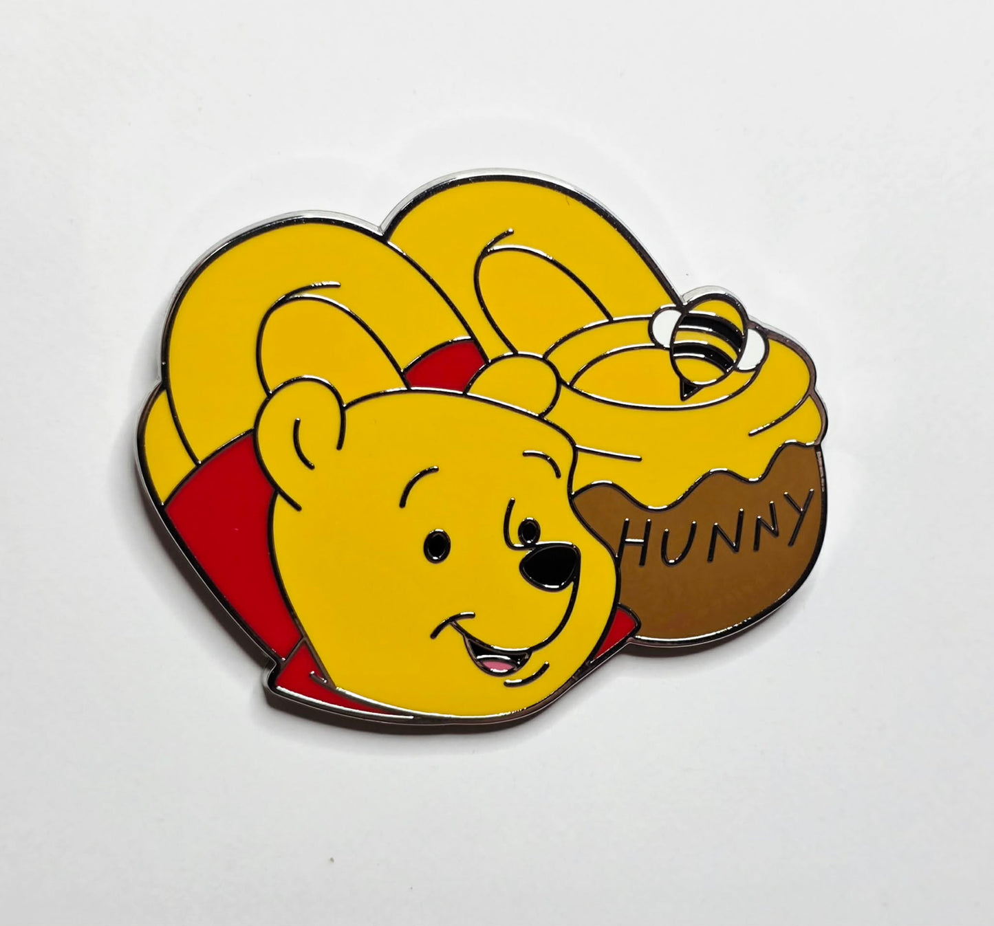 Winnie the Pooh with slippers and a "Hunny" pot.