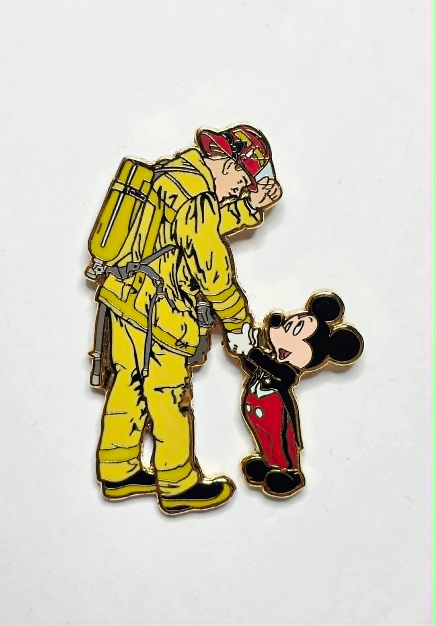 Mickey Mouse shaking hands with a firefighter