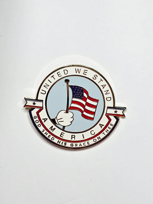 "United We Stand America" collectible pin featuring a patriotic design and gold-tone finish