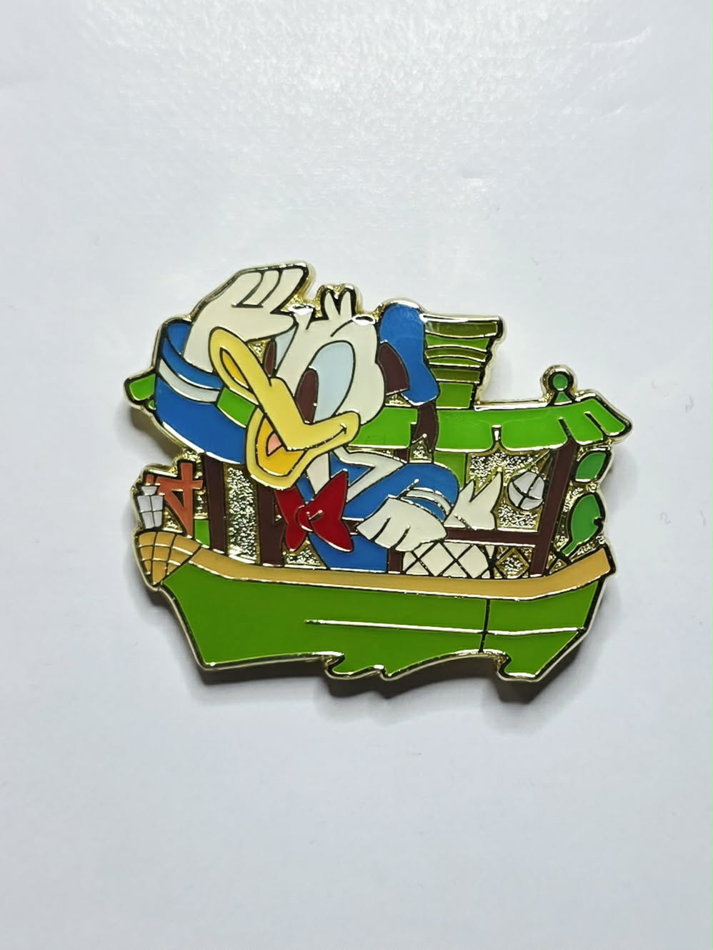 Donald Duck piloting a green Jungle Cruise boat
