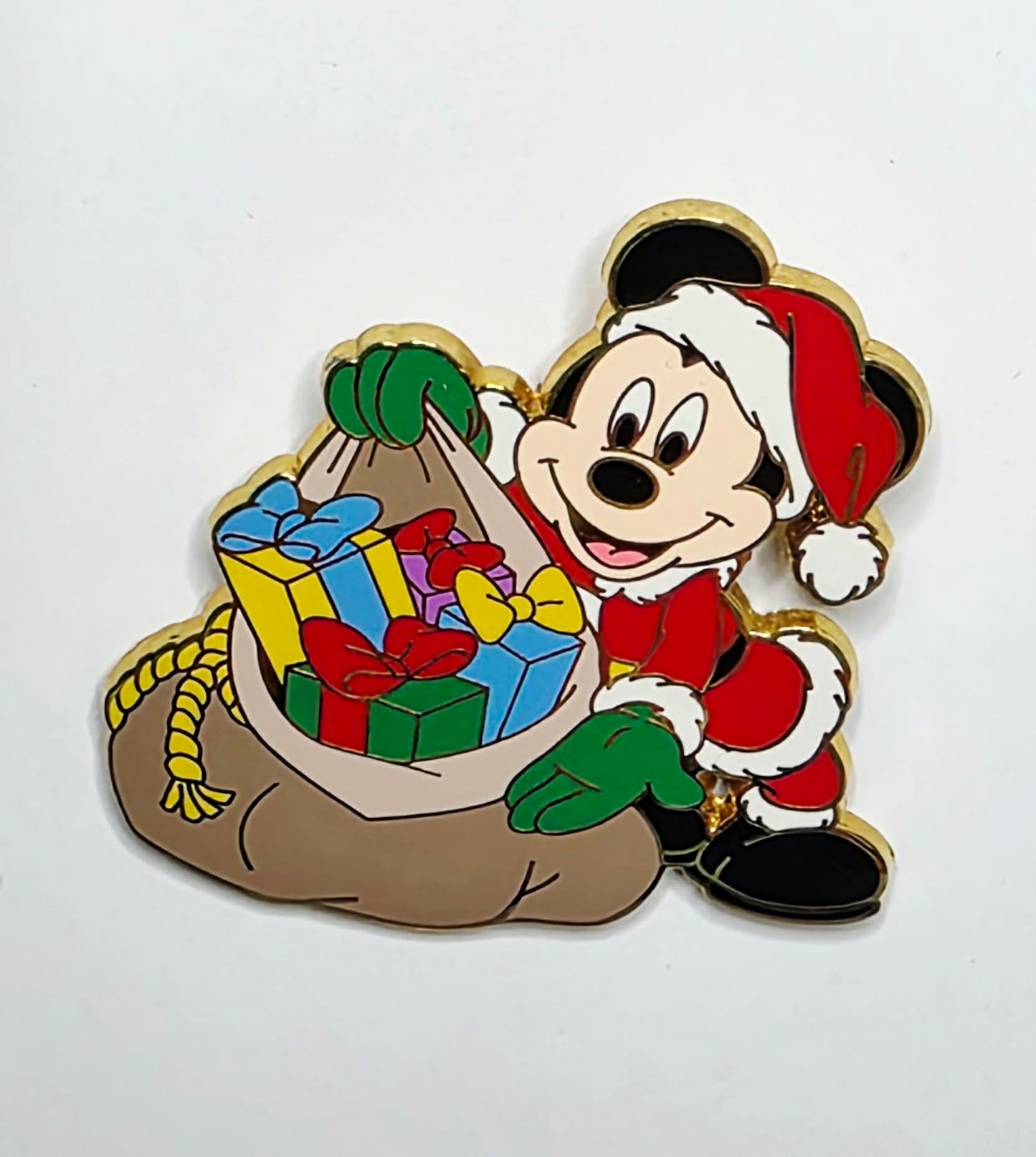 Mickey Mouse dressed as Santa Claus holding a sack full of presents