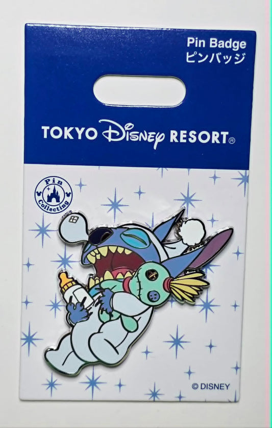 Stitch holding a bottle and the Scrump doll