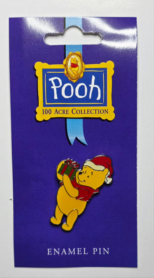 Winnie the Pooh - Winnie the Pooh wearing a Santa hat and holding a Christmas present.