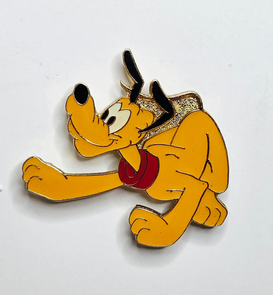 Pluto in a crawling or pouncing pose with a red collar