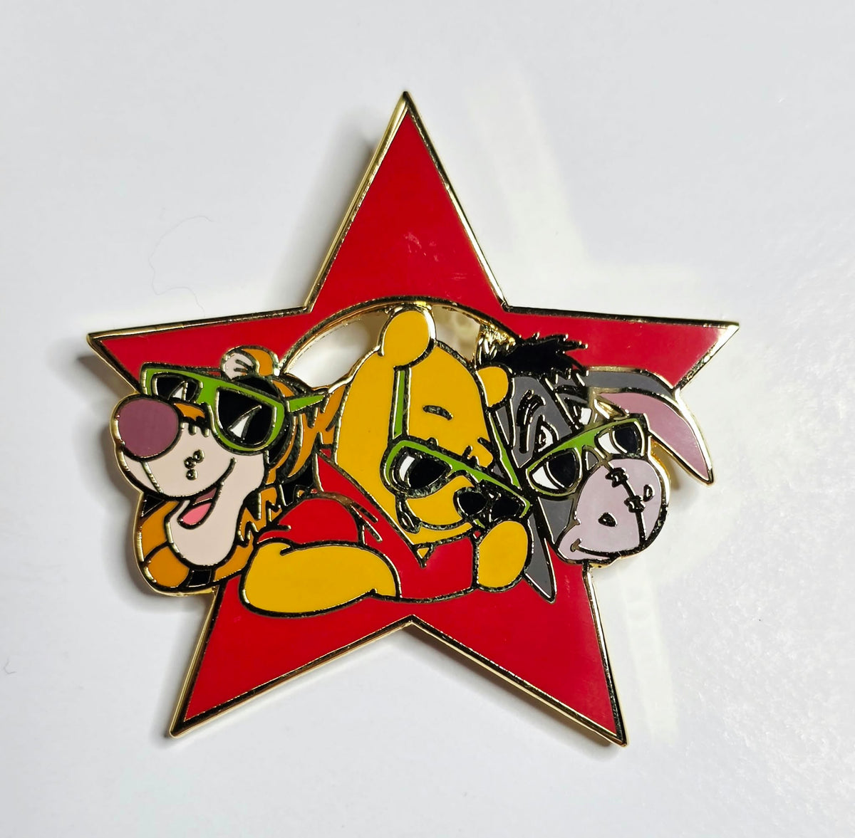 Winnie the Pooh, Tigger, and Eeyore wearing green sunglasses inside a red star,